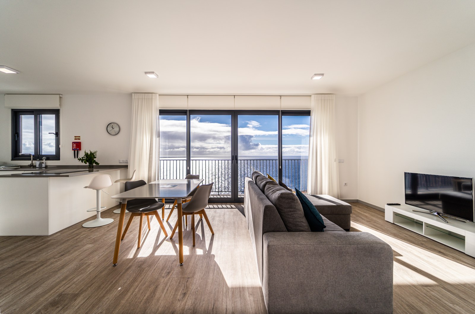 Open-plan dining and living area framed by the ocean view at Guesthouse Olival, Madeira
