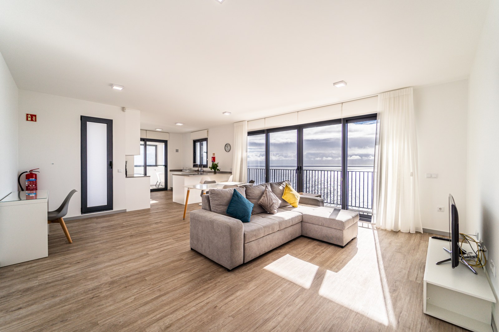 Bright open-plan living, dining and kitchen with sea-view balcony at Guesthouse Olival, Madeira