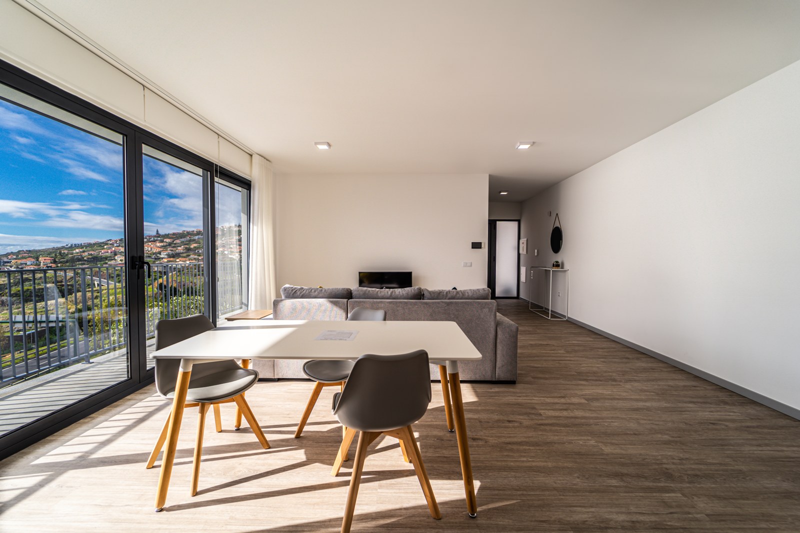 Living area with corner sofa, smart TV and balcony access at Guesthouse Olival, Madeira